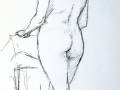 Female nude standing by chair